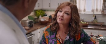 Movie still from “Father of the Bride” (2022), directed by Gary Alazraki – A person in a kitchen; Close Up shot, Over the shoulder angle