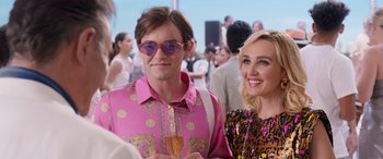 Movie still from “Father of the Bride” (2022), directed by Gary Alazraki – A man and a woman standing next to each other in front of a crowd; Medium shot, Over the shoulder angle