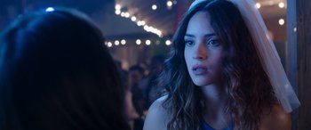 Movie still from “Father of the Bride” (2022), directed by Gary Alazraki – A person with long hair; Close Up shot, Over the shoulder angle