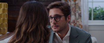 Movie still from “Father of the Bride” (2022), directed by Gary Alazraki – A man wearing glasses and a jacket is talking to a woman; Close Up shot, Over the shoulder angle