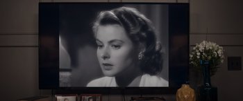 Movie still from “Father of the Bride” (2022), directed by Gary Alazraki – An old black and white photo of a woman in front of a television; Close Up shot, Over the shoulder angle