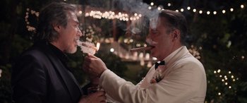 Movie still from “Father of the Bride” (2022), directed by Gary Alazraki – A couple of people that are smoking some food; Medium shot, Over the shoulder angle