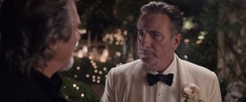 Movie still from “Father of the Bride” (2022), directed by Gary Alazraki – A man wearing a tuxedo and a bow tie; Close Up shot, Over the shoulder angle
