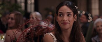 Movie still from “Father of the Bride” (2022), directed by Gary Alazraki – A person sitting at a table; Close Up shot, Over the shoulder angle