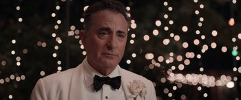 Movie still from “Father of the Bride” (2022), directed by Gary Alazraki – A person wearing a suit and a bow tie; Close Up shot, Over the shoulder angle