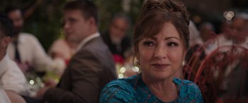 Movie still from “Father of the Bride” (2022), directed by Gary Alazraki – A person sitting at a table; Close Up shot, Over the shoulder angle