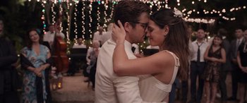 Movie still from “Father of the Bride” (2022), directed by Gary Alazraki – A man and a woman kissing each other in front of lights; Close Up shot, Over the shoulder angle