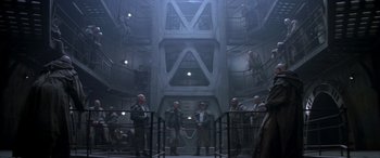 Movie still from “Alien³” (1992), directed by David Fincher – A group of men standing inside of a building; Wide shot, High angle