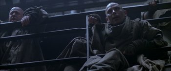 Movie still from “Alien³” (1992), directed by David Fincher – A man sitting on a chair in a dark room; Medium shot, Low angle