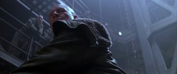 Movie still from “Alien³” (1992), directed by David Fincher – A man in a hooded jacket standing in a room; Close Up shot, Low angle