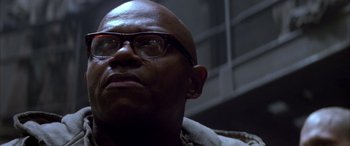 Movie still from “Alien³” (1992), directed by David Fincher – A bald man with glasses is looking upward; Close Up shot, Low angle