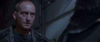 Movie still from “Alien³” (1992), directed by David Fincher – A person in a dark room; Close Up shot, Over the shoulder angle