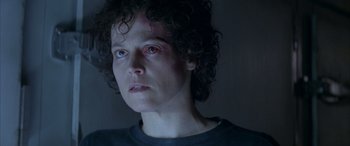 Movie still from “Alien³” (1992), directed by David Fincher – A person wearing a black t - shirt; Close Up shot, Low angle