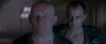Movie still from “Alien³” (1992), directed by David Fincher – A man with a shaved head and a man with a shaved head; Close Up shot, Low angle
