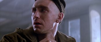 Movie still from “Alien³” (1992), directed by David Fincher – A person wearing a hat; Close Up shot, Over the shoulder angle