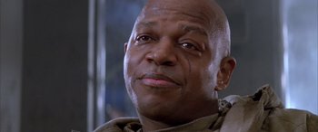 Movie still from “Alien³” (1992), directed by David Fincher – A person looking at the camera; Close Up shot, Low angle