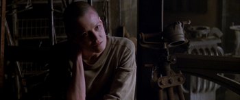 Movie still from “Alien³” (1992), directed by David Fincher – A man with a shaved head sitting in a room; Close Up shot, Low angle