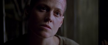 Movie still from “Alien³” (1992), directed by David Fincher – A man with a shaved head looking into the camera; Close Up shot, Low angle