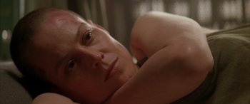 Movie still from “Alien³” (1992), directed by David Fincher – A person laying on their stomach; Close Up shot, Over the shoulder angle