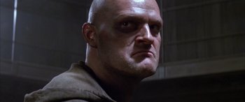 Movie still from “Alien³” (1992), directed by David Fincher – A person with a bald head; Close Up shot, Low angle