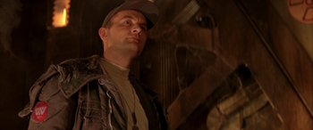 Movie still from “Alien³” (1992), directed by David Fincher – A man wearing a hat and a jacket looking to his left; Close Up shot, Low angle