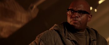 Movie still from “Alien³” (1992), directed by David Fincher – A man with glasses is looking at the camera; Close Up shot, Low angle