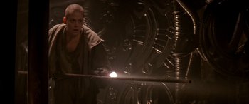 Movie still from “Alien³” (1992), directed by David Fincher – A man standing in front of a wall with a flashlight; Medium shot, Low angle