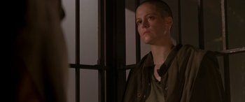 Movie still from “Alien³” (1992), directed by David Fincher – A woman standing in front of a jail cell; Close Up shot, Low angle