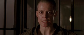 Movie still from “Alien³” (1992), directed by David Fincher – A person with a bald head; Close Up shot, Low angle