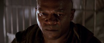 Movie still from “Alien³” (1992), directed by David Fincher – A man's face in a dark room; Close Up shot, Low angle