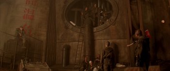 Movie still from “Alien³” (1992), directed by David Fincher – A group of men sitting on top of a building; Wide shot, Low angle