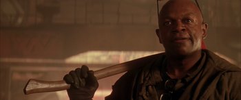 Movie still from “Alien³” (1992), directed by David Fincher – A man holding a baseball bat in his hands; Close Up shot, Low angle