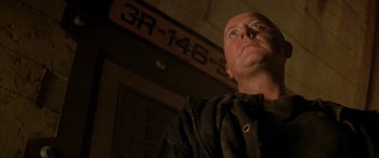 Movie still from “Alien³” (1992), directed by David Fincher – A bald man looking up into the ceiling; Close Up shot, Low angle