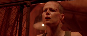 Movie still from “Alien³” (1992), directed by David Fincher – A person with a shaved head and a piercing; Close Up shot, Low angle