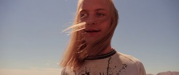 Movie still from “Fear and Loathing in Las Vegas” (1998), directed by Terry Gilliam – A man with long blonde hair is posing for a picture; Close Up shot, Low angle