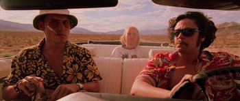 Movie still from “Fear and Loathing in Las Vegas” (1998), directed by Terry Gilliam – A group of people sitting in the back of a car; Medium shot, Low angle