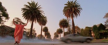 Movie still from “Fear and Loathing in Las Vegas” (1998), directed by Terry Gilliam – A car driving down a street next to palm trees; Extreme Wide shot, Low angle