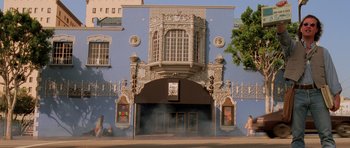 Movie still from “Fear and Loathing in Las Vegas” (1998), directed by Terry Gilliam – A building that has a lot of art work on the outside of the building; Extreme Wide shot, Low angle