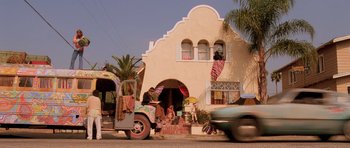 Movie still from “Fear and Loathing in Las Vegas” (1998), directed by Terry Gilliam – A truck driving down a street next to a building; Wide shot, Low angle