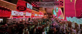 Movie still from “Fear and Loathing in Las Vegas” (1998), directed by Terry Gilliam – A crowd of people walking down a street at night; Extreme Wide shot, High angle