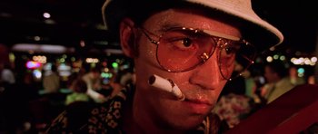 Movie still from “Fear and Loathing in Las Vegas” (1998), directed by Terry Gilliam – A person with a cigarette in his mouth; Close Up shot, Low angle