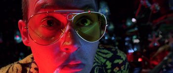 Movie still from “Fear and Loathing in Las Vegas” (1998), directed by Terry Gilliam – A person wearing a pair of sunglasses; Close Up shot, Low angle