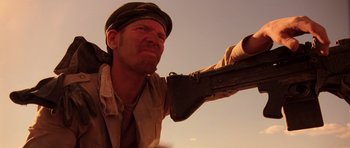 Movie still from “Fear and Loathing in Las Vegas” (1998), directed by Terry Gilliam – A man holding a gun in his right hand; Close Up shot, Low angle