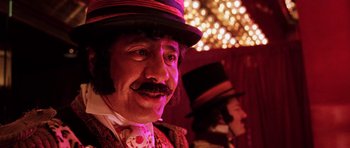 Movie still from “Fear and Loathing in Las Vegas” (1998), directed by Terry Gilliam – A person wearing a top hat; Close Up shot, Low angle