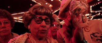 Movie still from “Fear and Loathing in Las Vegas” (1998), directed by Terry Gilliam – An older woman wearing glasses and a cowboy hat; Close Up shot, Low angle