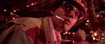 Movie still from “Fear and Loathing in Las Vegas” (1998), directed by Terry Gilliam – A person smoking a cigarette; Close Up shot, Low angle