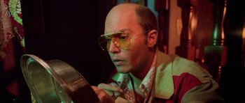 Movie still from “Fear and Loathing in Las Vegas” (1998), directed by Terry Gilliam – A bald man in glasses looking at a mirror; Close Up shot, Low angle