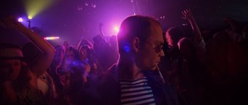 Movie still from “Fear and Loathing in Las Vegas” (1998), directed by Terry Gilliam – A man in a crowd of people at a party; Close Up shot, Low angle