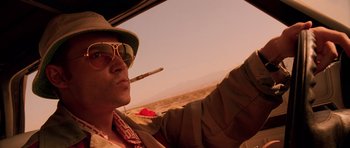 Movie still from “Fear and Loathing in Las Vegas” (1998), directed by Terry Gilliam – A man smoking a cigarette while sitting in a car; Close Up shot, Low angle
