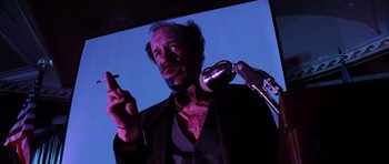 Movie still from “Fear and Loathing in Las Vegas” (1998), directed by Terry Gilliam – A man with a beard is holding a microphone; Close Up shot, Low angle